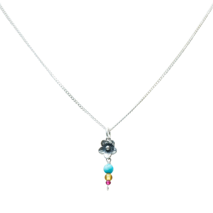 Dije Flor Mini Con Turquesa, joya de plata .925, con ámbar y rubí – Gabriela Sánchez